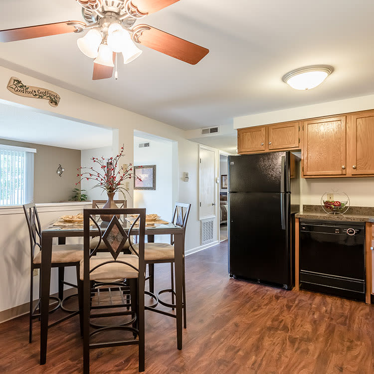 Dining table and kitchen at Maplewood Estates Apartments home