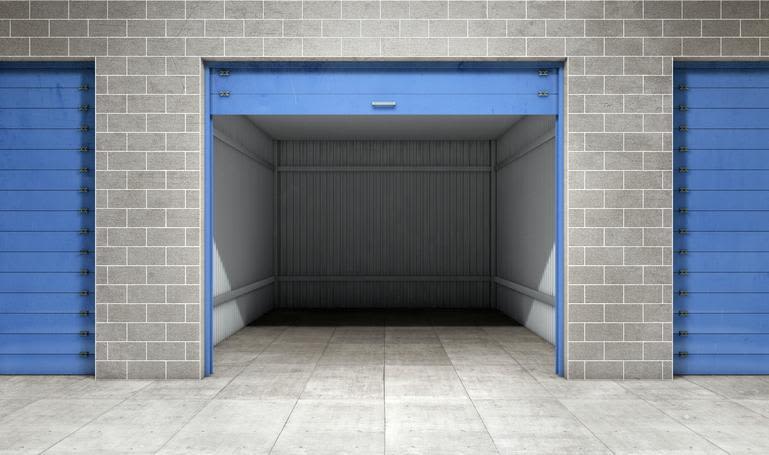 Open self storage unit made of grey bricks with blue door