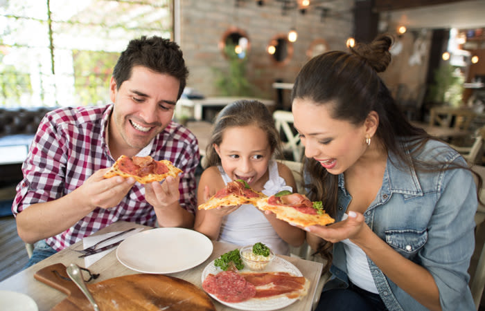 A young family sharing dinner out near Widdicombe Place in Etobicoke