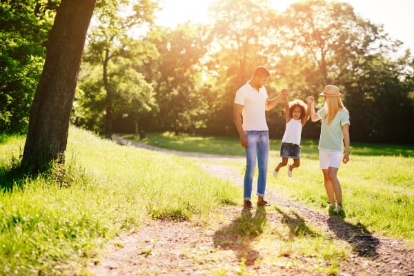 A young family enjoying green space near Saskatoon Tower in Saskatoon