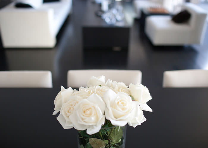 White roses and modern decor in an apartment at The Waterford Tower in Mississauga, Ontario.