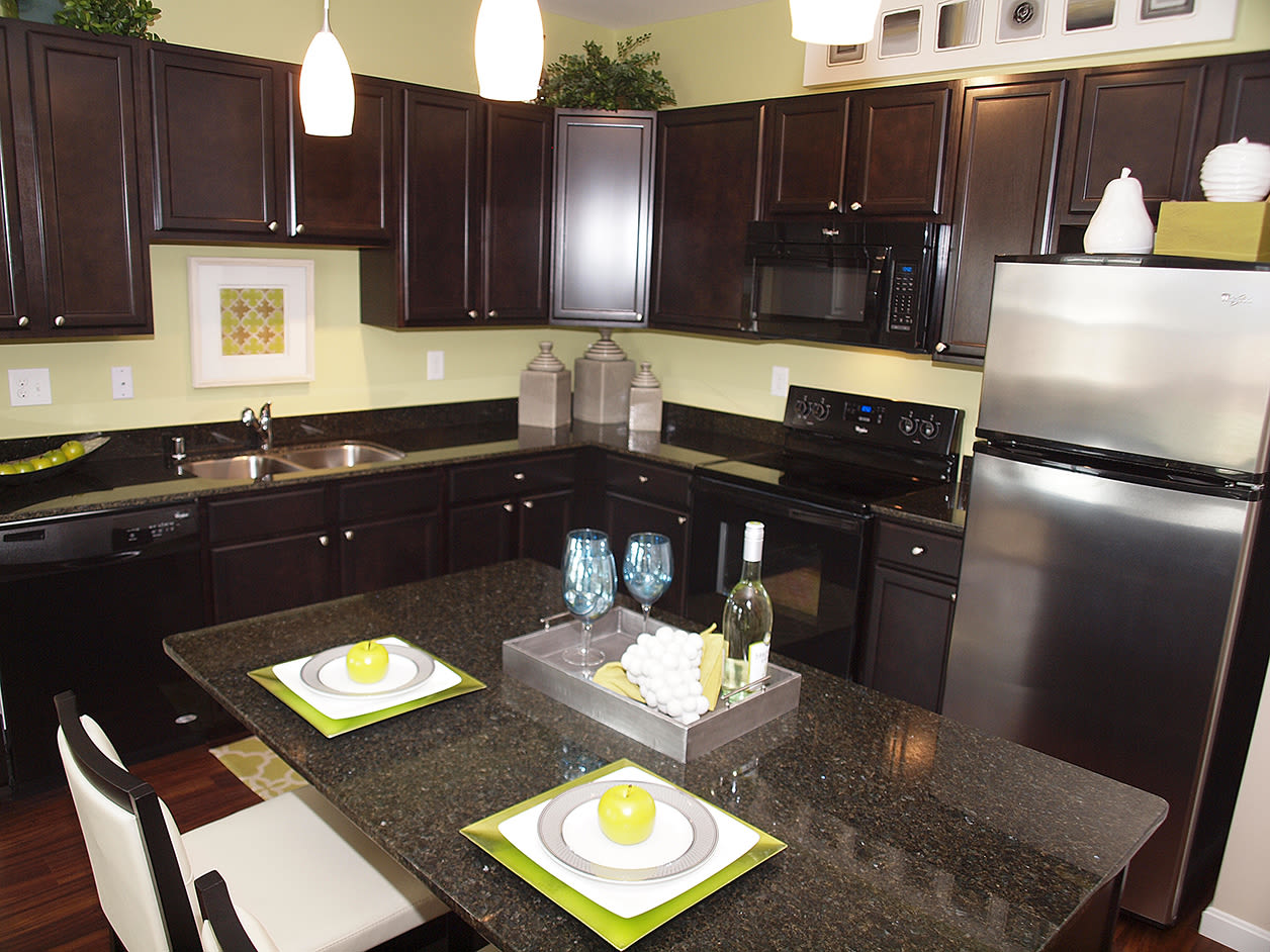 Modern kitchen featuring a stainless steel refrigerator at Meridian on Shelbyville in Louisville, Kentucky 