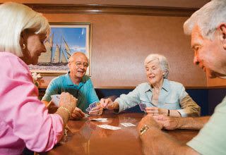 Residents playing cards at Florida senior living communities