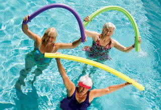 Senior living residents having fun while doing pool activities in Bonita Springs, Florida