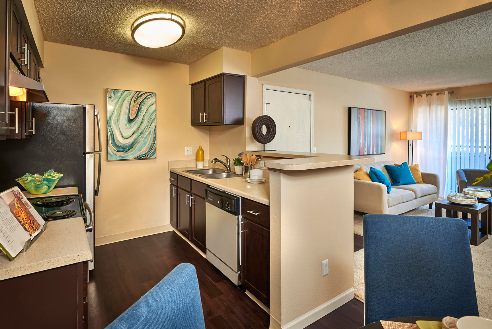 Kitchen with wood-style flooring at Alton Green Apartments in Denver, Colorado
