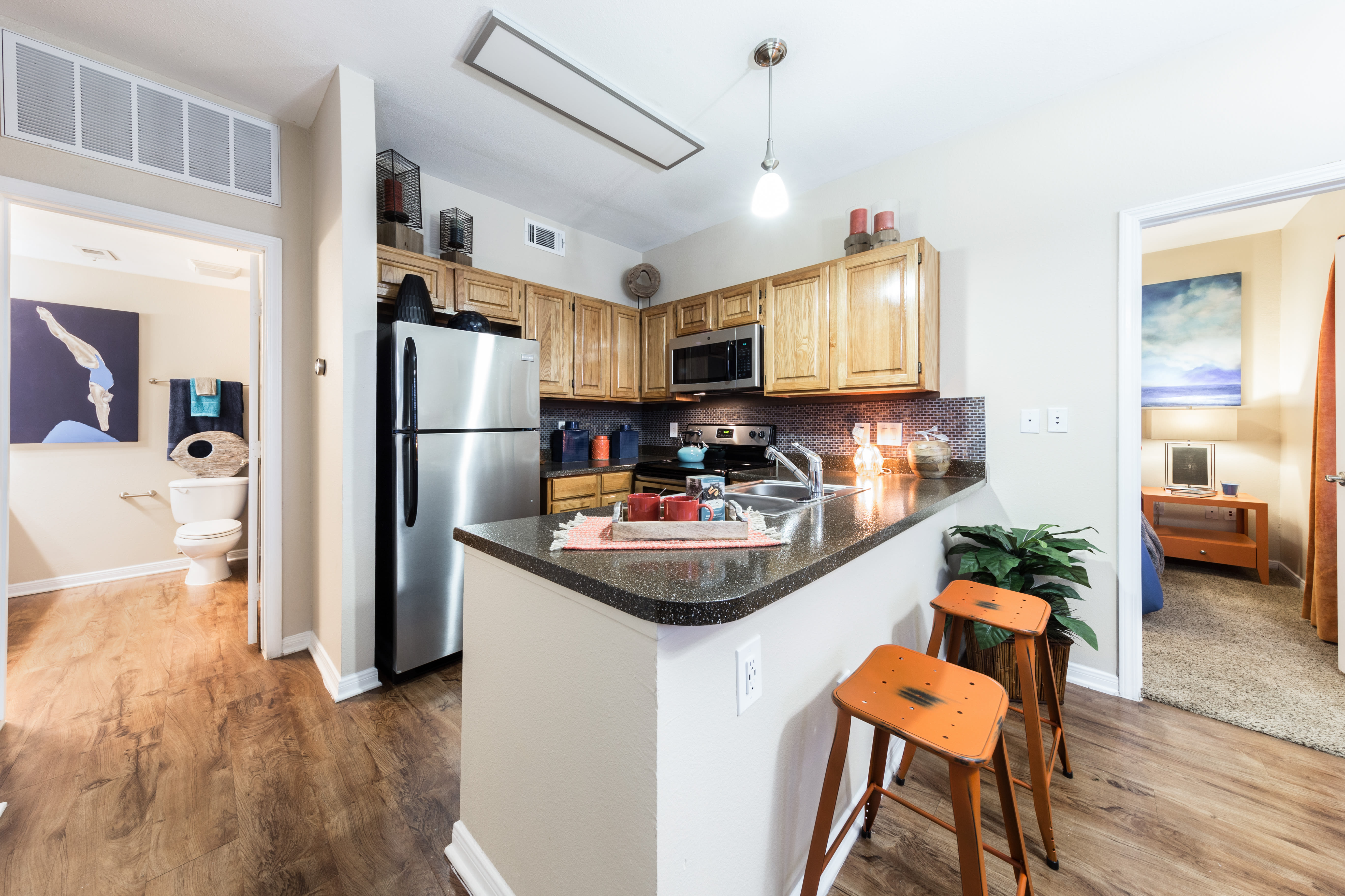 Kitchen with bar seating at Pavilions at Northshore in Portland, Texas