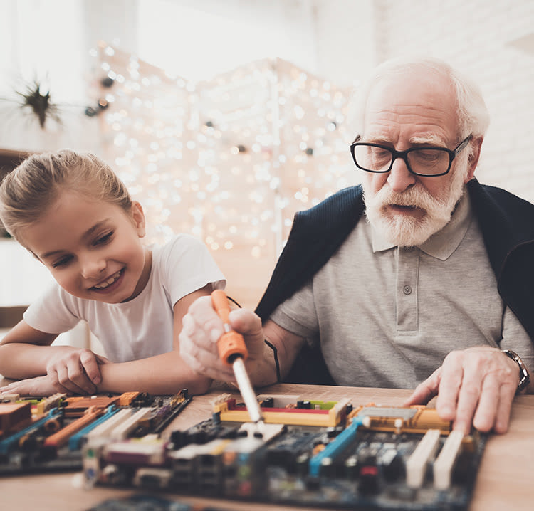 Resident and grandchild working in the shop at Chancellor Gardens in Clearfield, Utah