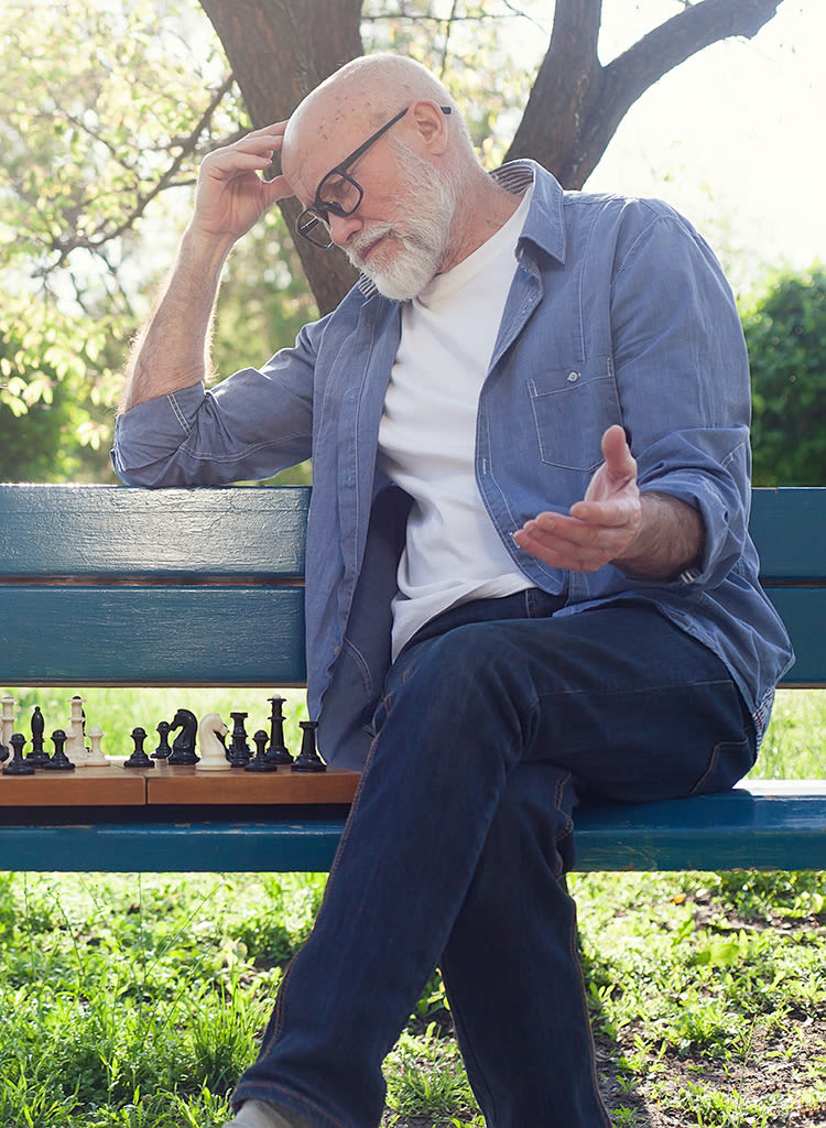 A resident of The Palisades at Broadmoor Park strategically playing chess
