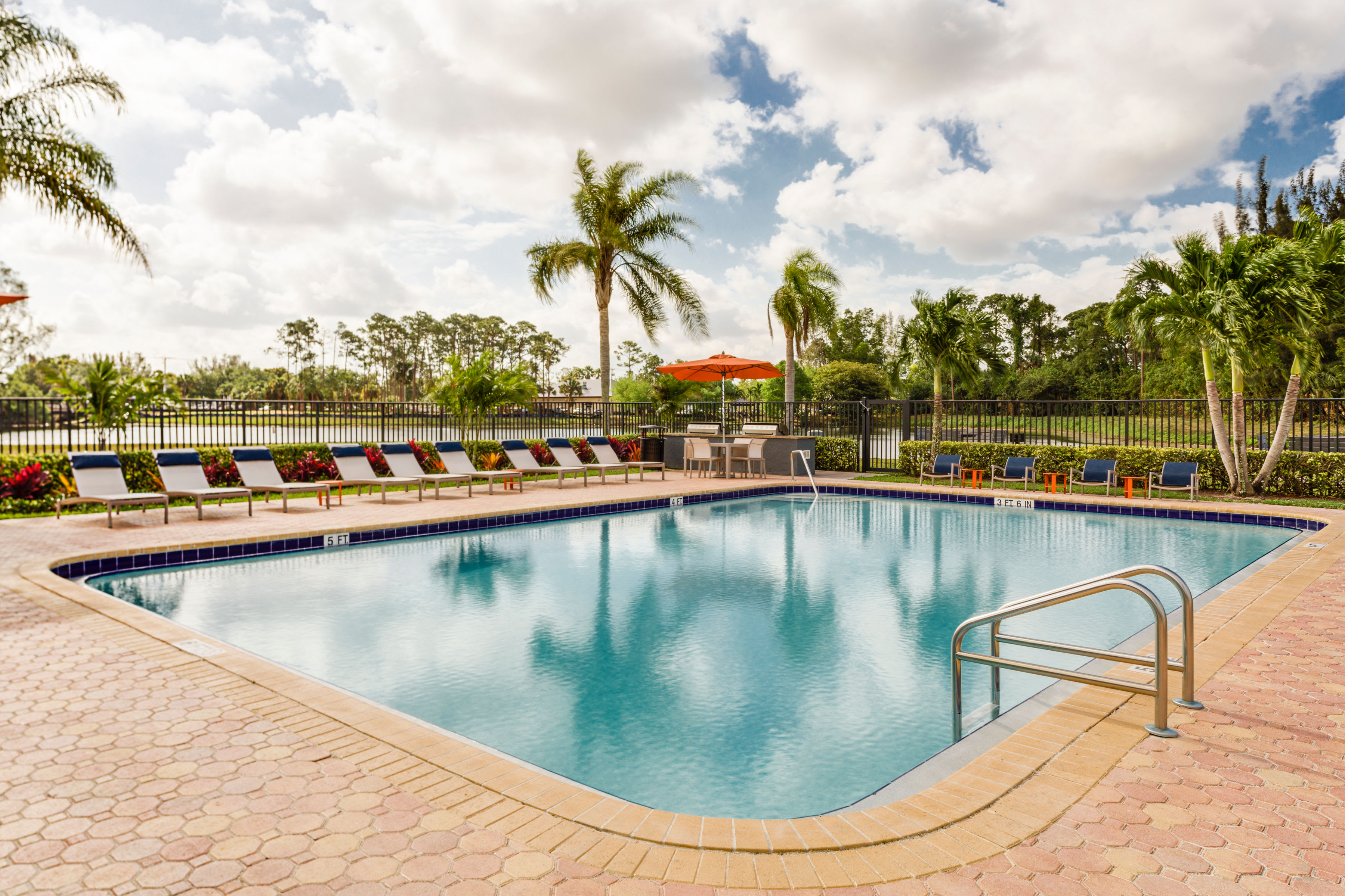 Picnic area with views of the lake at Verse at Royal Palm Beach in Royal Palm Beach, Florida