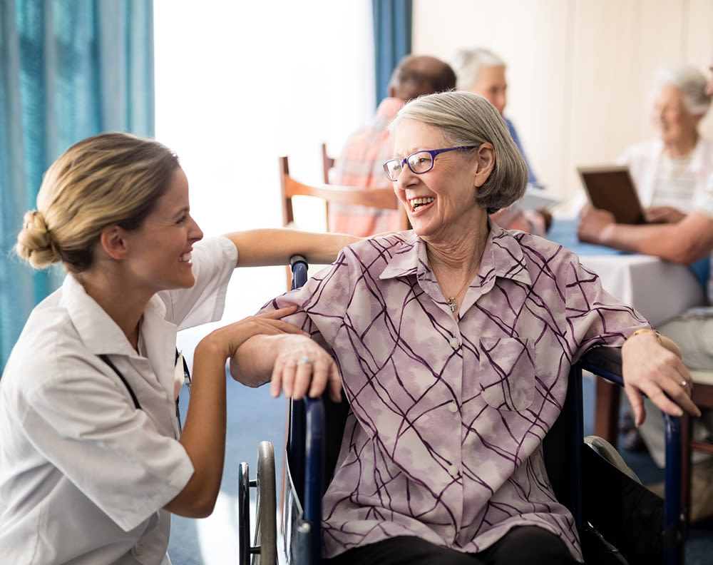 Woman laughing with senior resident at The Commons at Dallas Ranch in Antioch, California