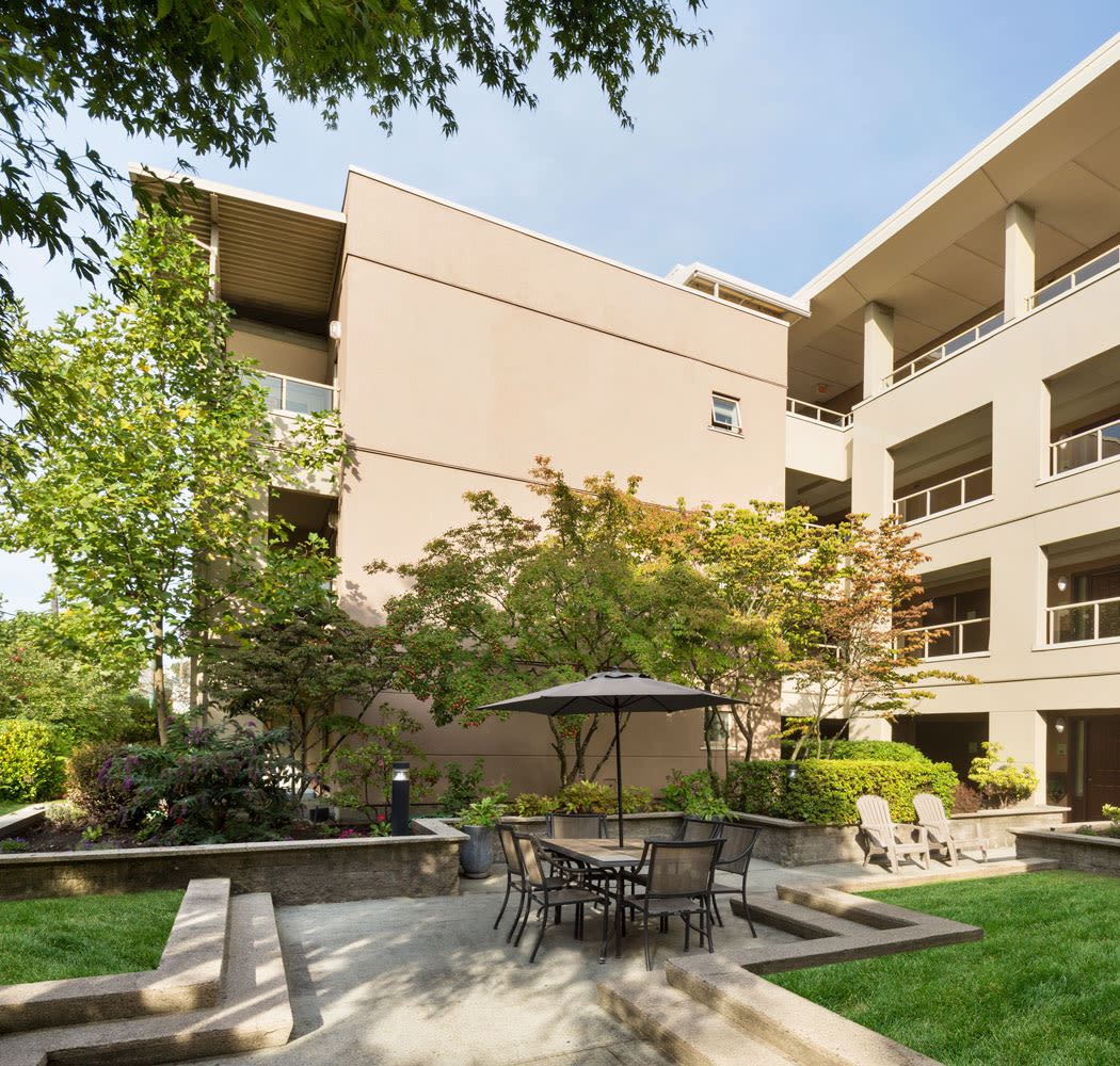 Outdoor dining area with well kept landscaping at Dunway Court in Vancouver, BC