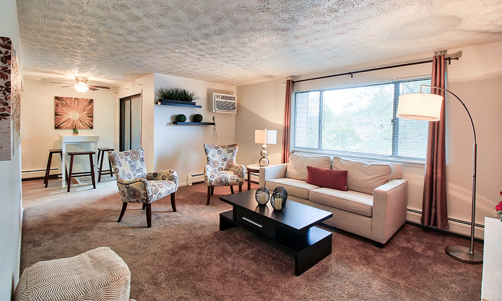 Spacious living room at Webster Manor Apartments in Webster, New York