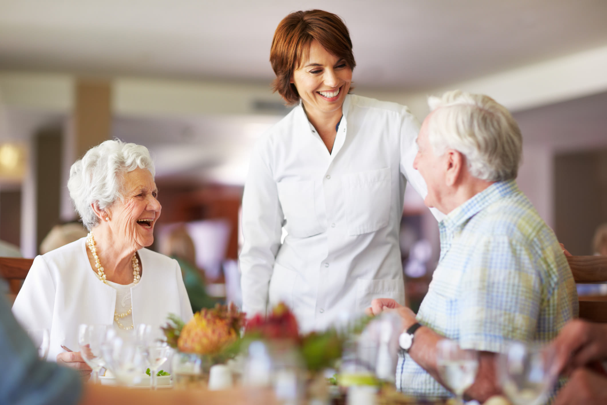 A server speaking with residents at Almond Heights in Orangevale, California