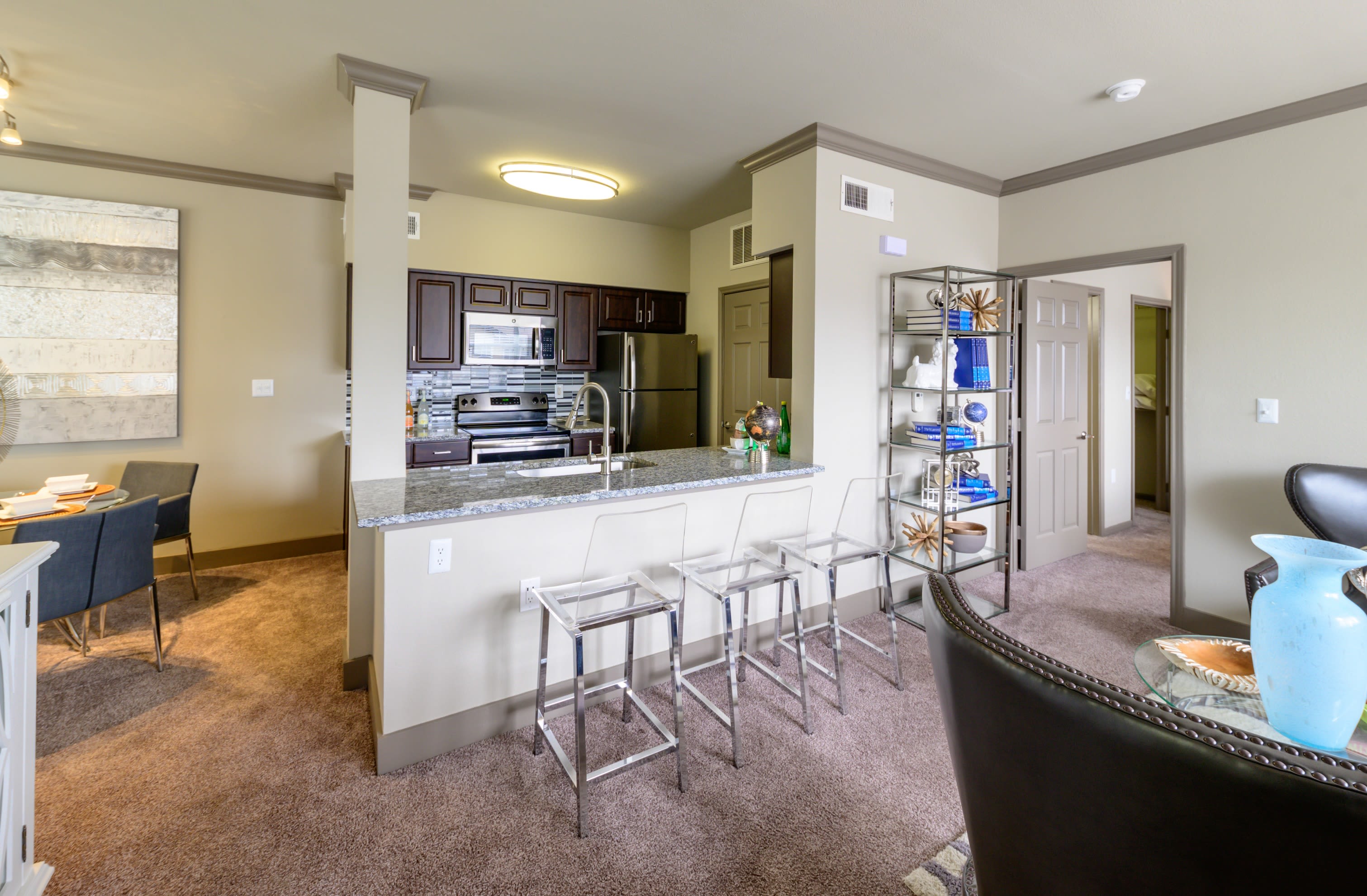 Open-concept floor plan with plush carpeting of model home at Artisan at Lake Wyndemere in The Woodlands, Texas