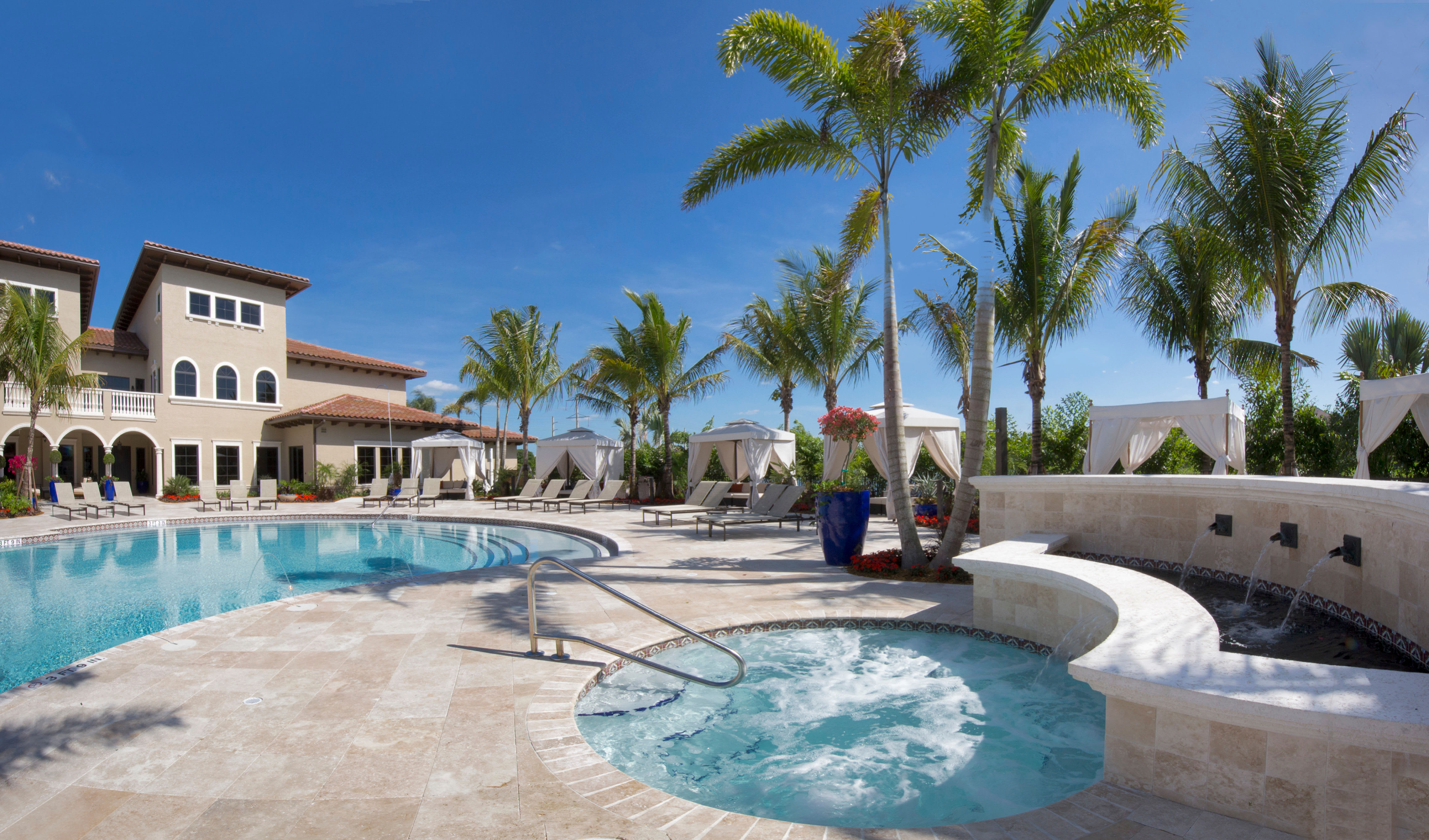 Spa area with nearby cabanas at Town Fontainebleau Lakes Apartment Residences in Miami, Florida