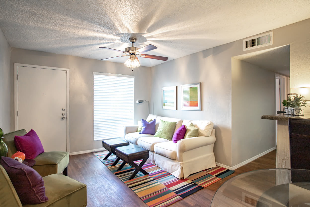 Living room with large windows at Willowick Apartments in College Station, Texas