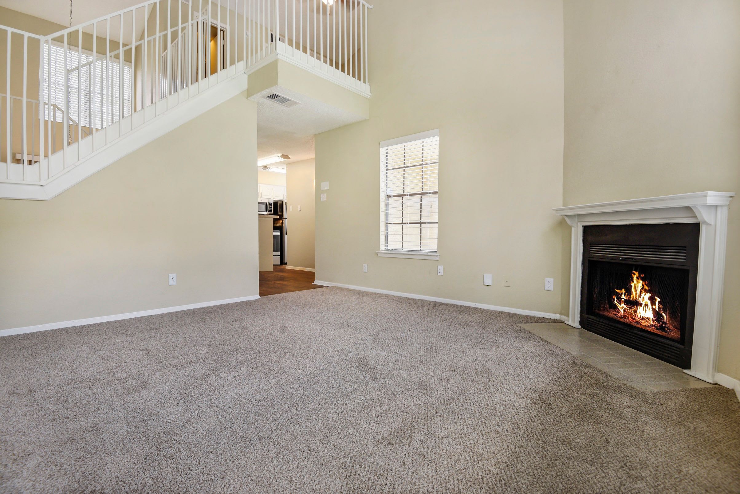 Wood-style floors with fireplace at The Regent in Dallas, Texas