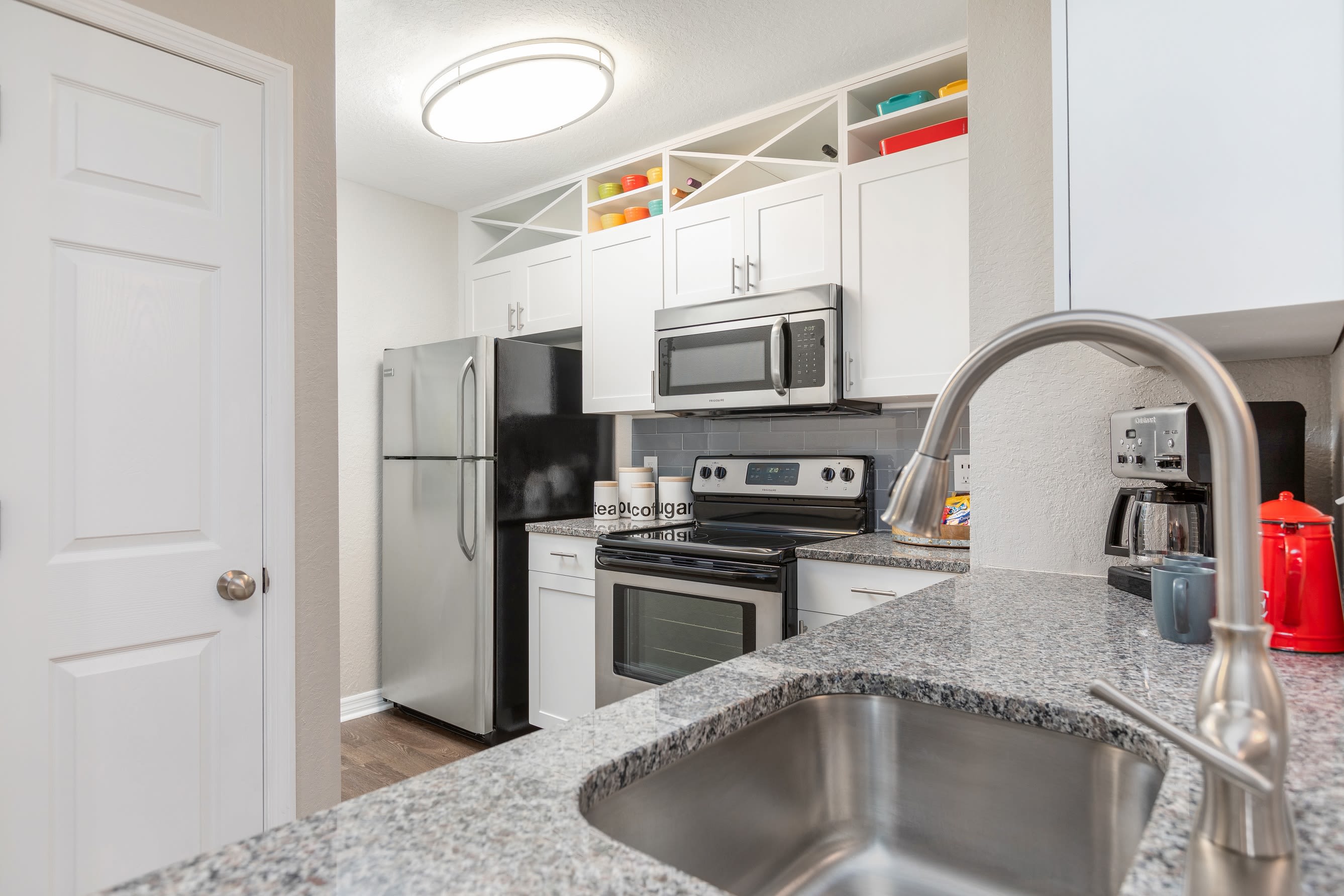 Modern decor and hardwood floors in open-concept living area of model home at Amira at Westly in Tampa, Florida