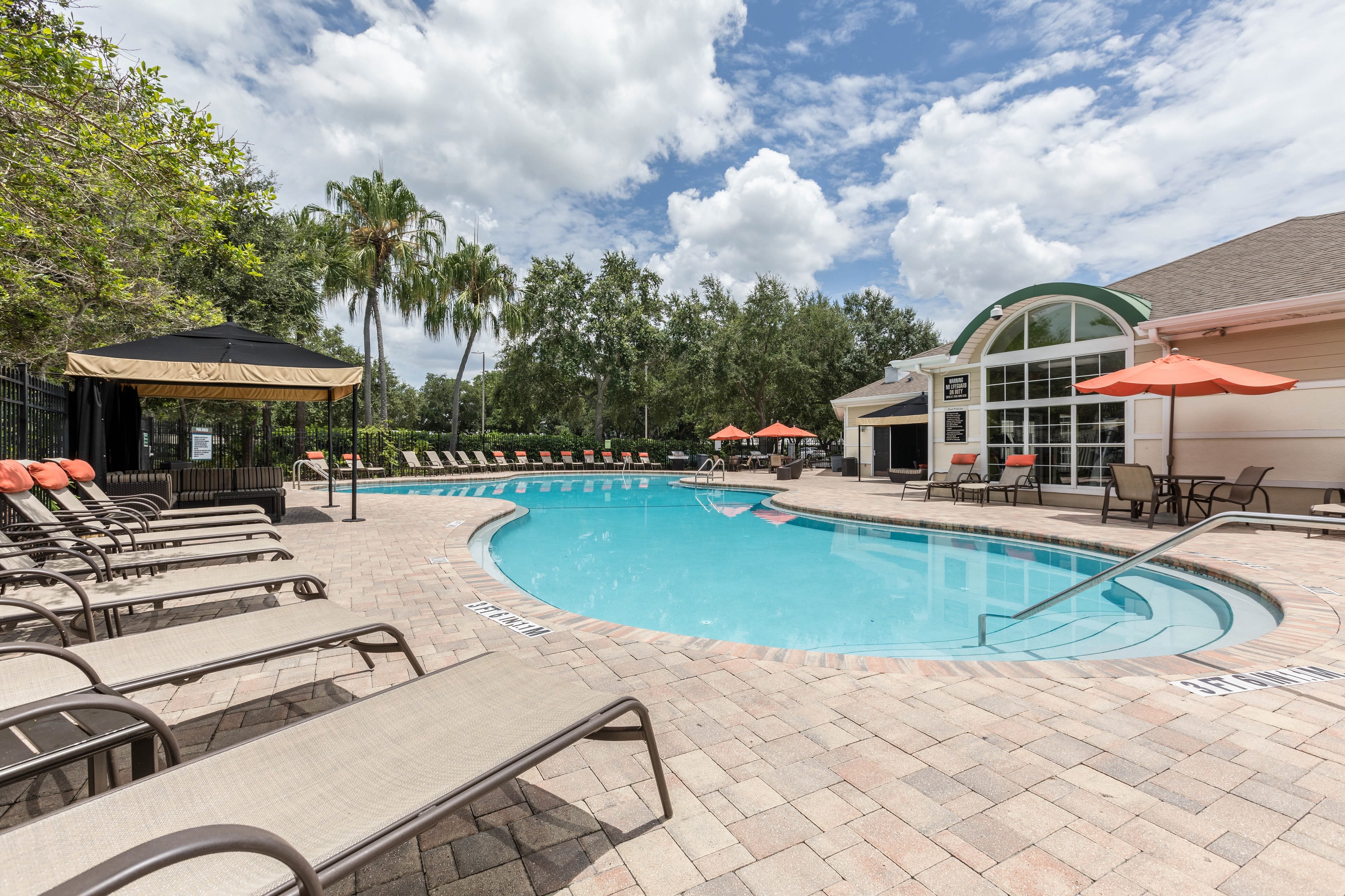 Resident enjoying the resort-style pool and sundeck at Amira at Westly in Tampa, Florida