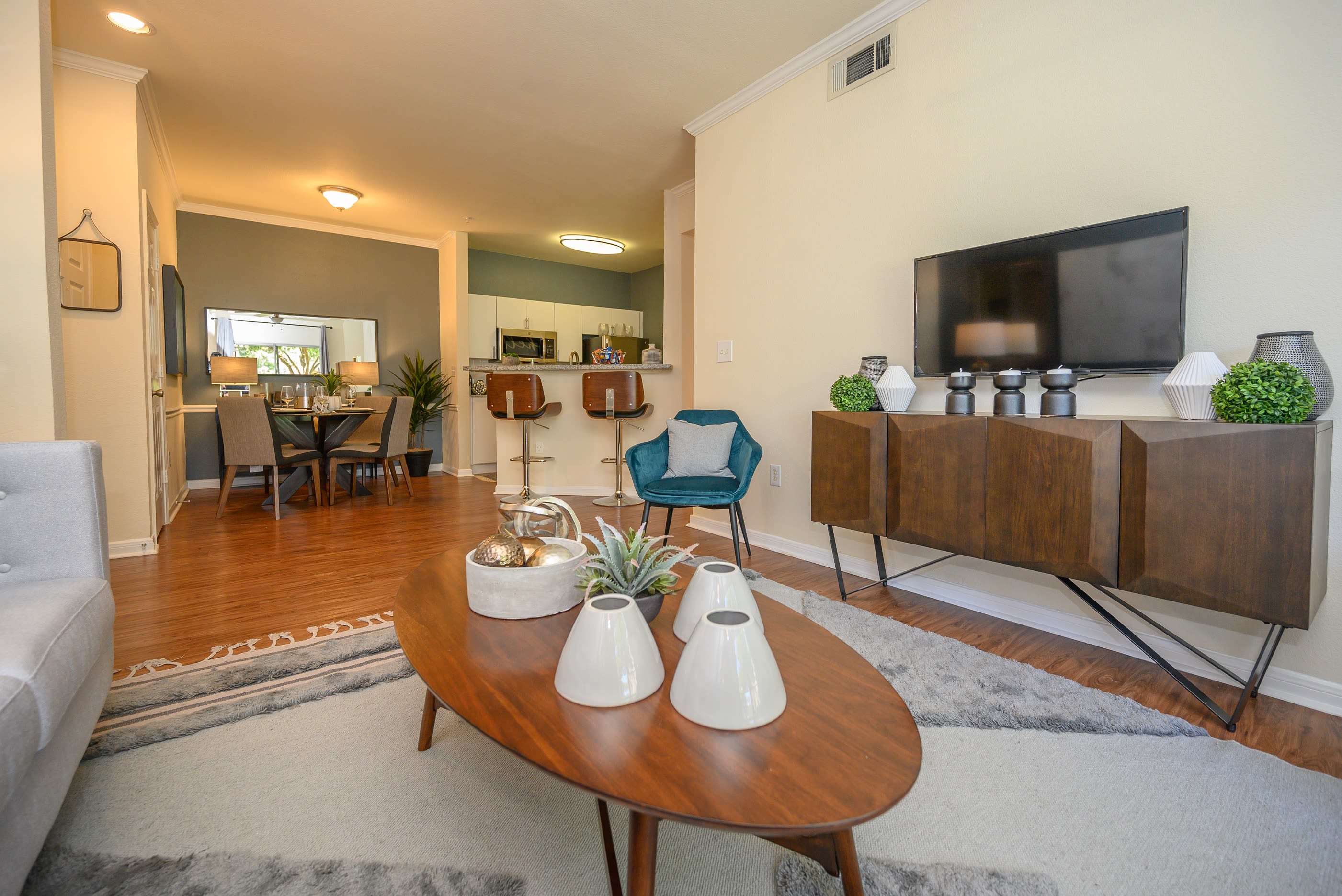 Open-concept living area with ceiling fan in model home at The View at Lakeside in Lewisville, Texas