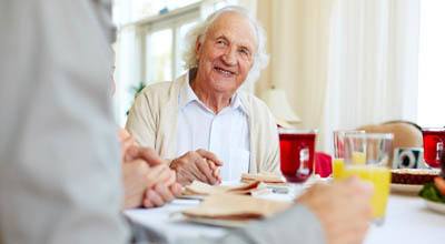 Happy resident enjoying a meal at Symphony at Cherry Hill in Cherry Hill, New Jersey.