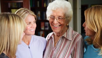 Assisted living resident laughs with staff at Reunion Court of The Woodlands in The Woodlands, Texas