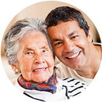 A resident and caregiver laugh together at Wyndham Court of Plano in Plano, Texas