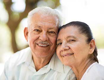 Elderly couple pose for a photo at Wyndham Court of Plano in Plano, Texas