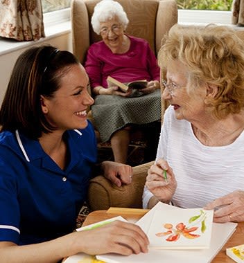 Staff talking with resident at The Phoenix at Johnson Ferry in Marietta, GA