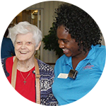 A resident and caregiver laugh together at Parkview on Hollybrook in Longview