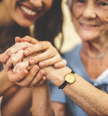 Resident and daughter holding hands at The Phoenix at Union Hill in Canton, GA