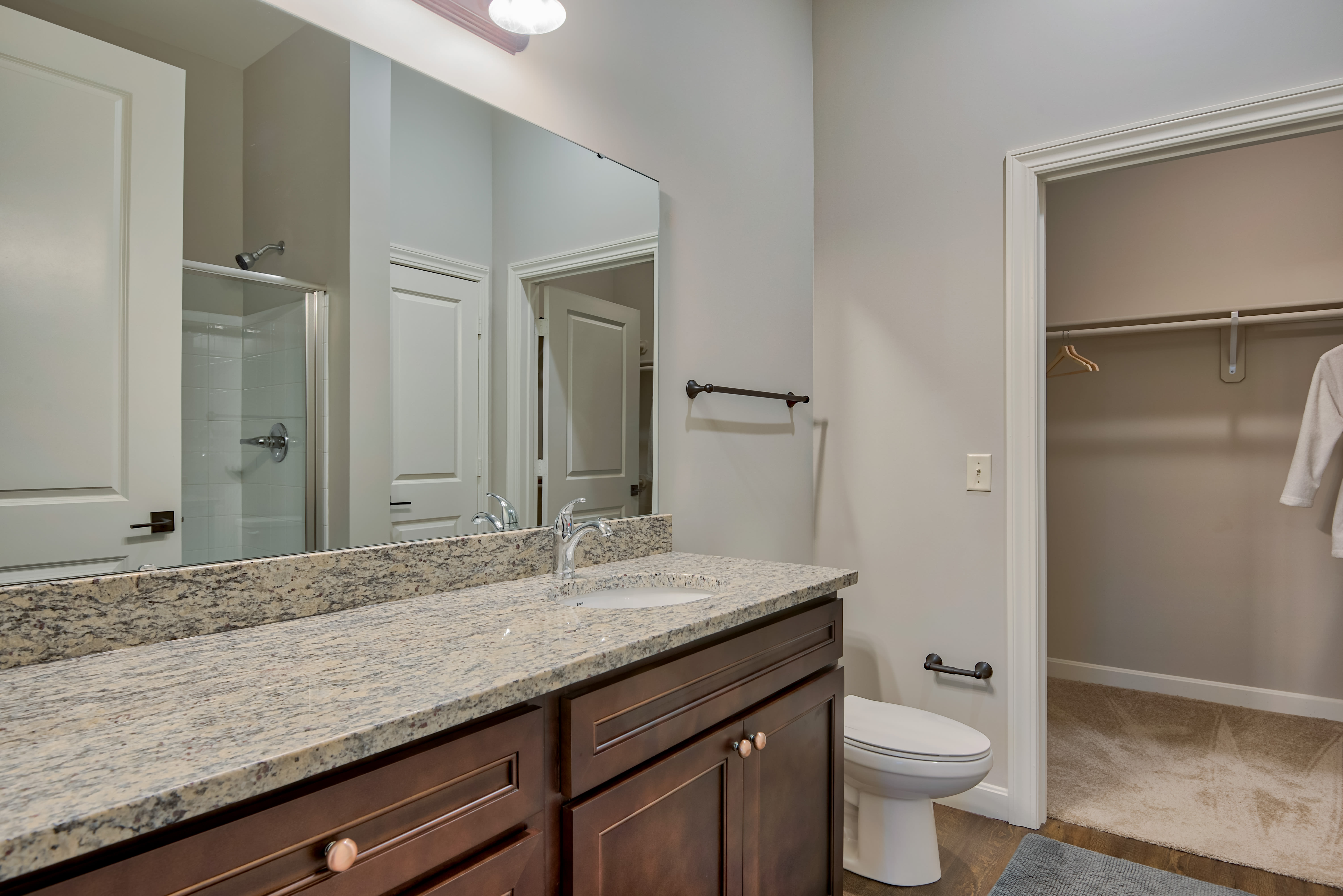 Granite counter tops and a glass shower in the bathroom at Boulders at Overland Park Apartments in Overland Park, Kansas