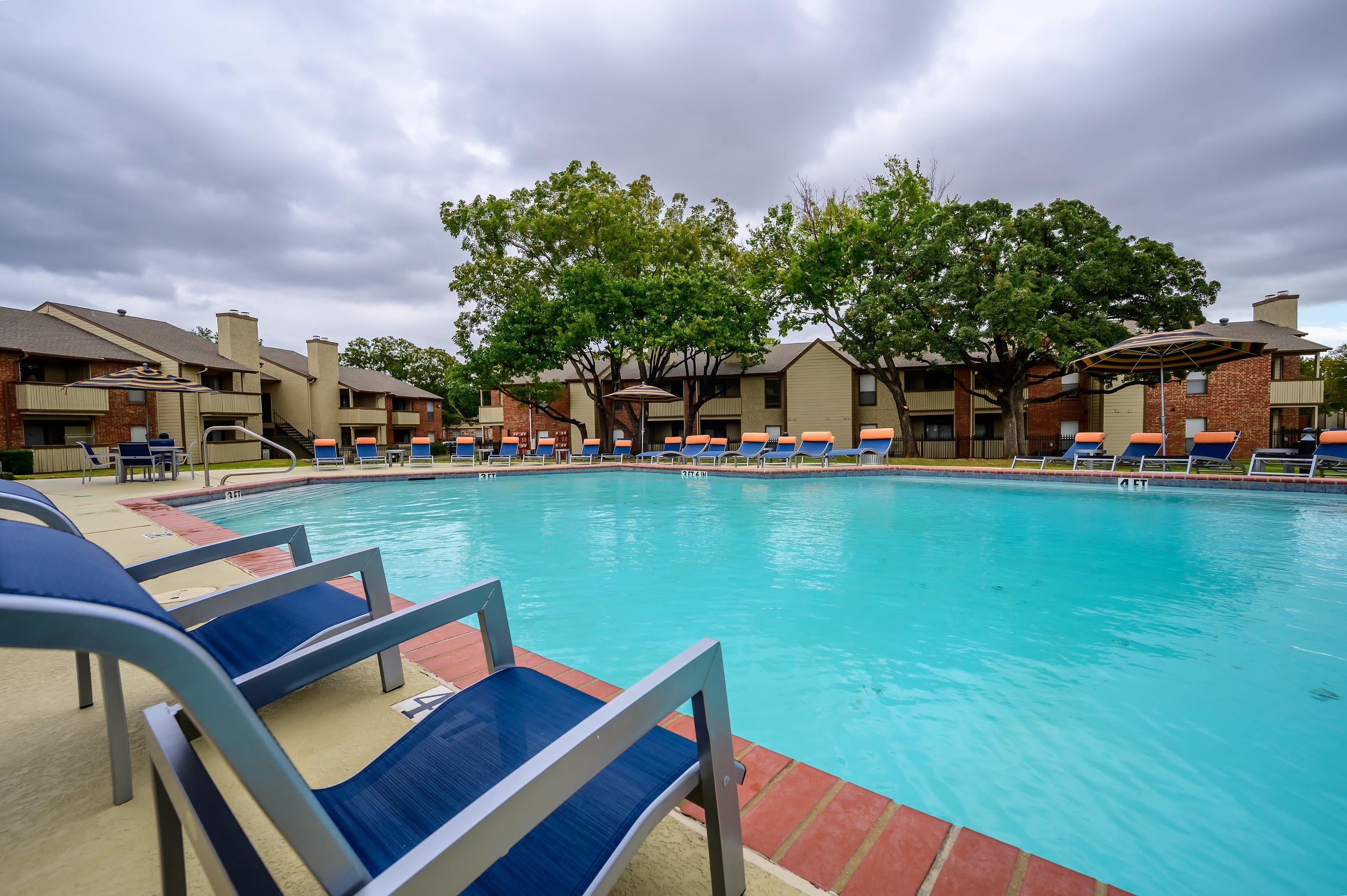 Lounge chairs poolside at The Logan in Bedford, Texas