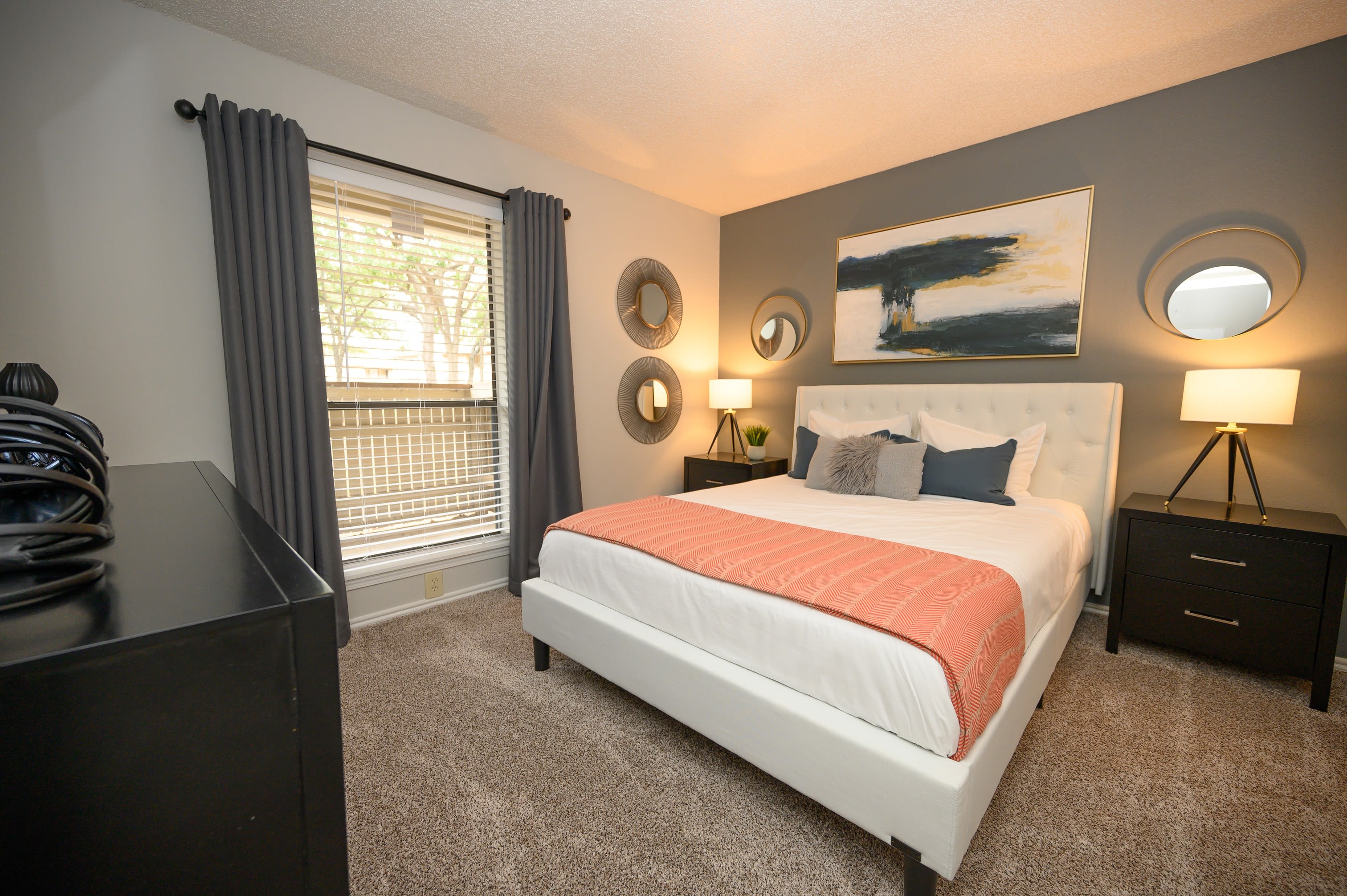 Well lit model bedroom at The Logan in Bedford, Texas