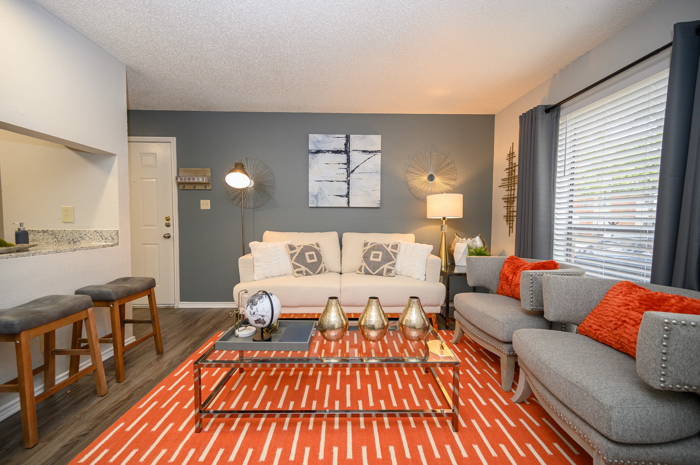 Open concept floor plan with hardwood floors and modern decor at The Logan in Bedford, Texas