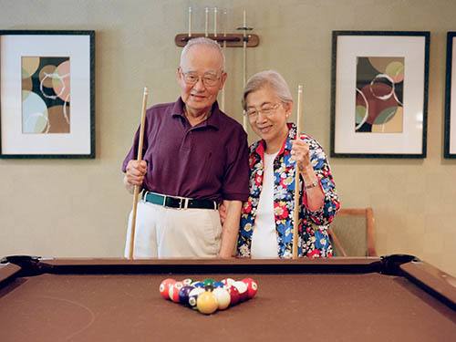 Seniors playing billiards at Merrill Gardens at Rolling Hills Estates in Rolling Hills Estates, California