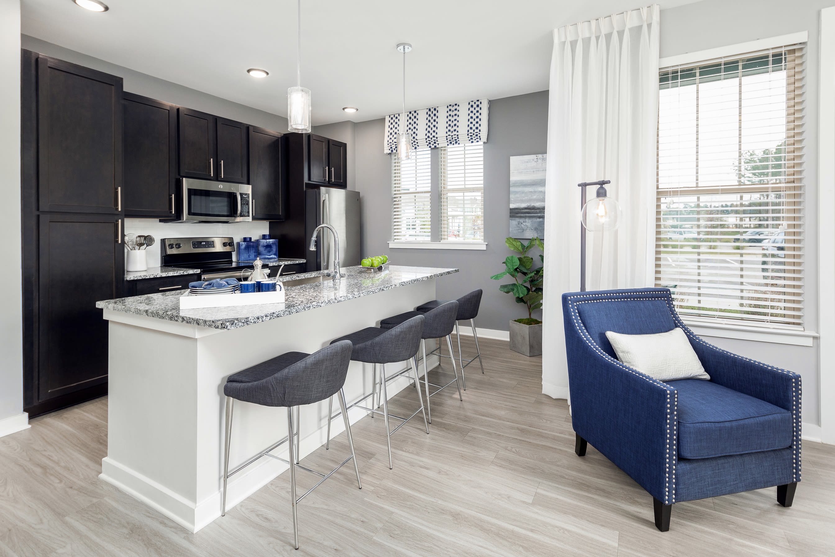 Open-concept floor plan with hardwood floors in the living area of model home at Elevate at Brighton Park in Summerville, South Carolina