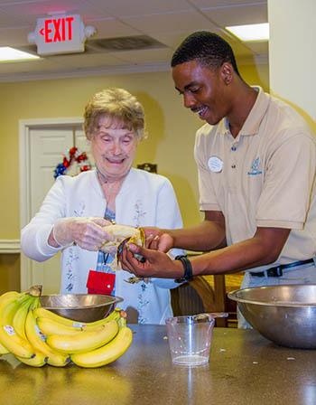 Senior woman and an employee at The Retreat at Canton baking in Canton, Georgia