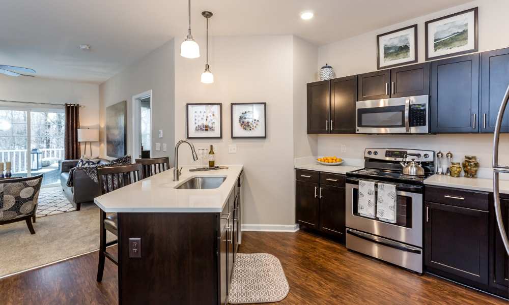 Well-equipped kitchen with island at The Links at CenterPointe Townhomes in Canandaigua, New York