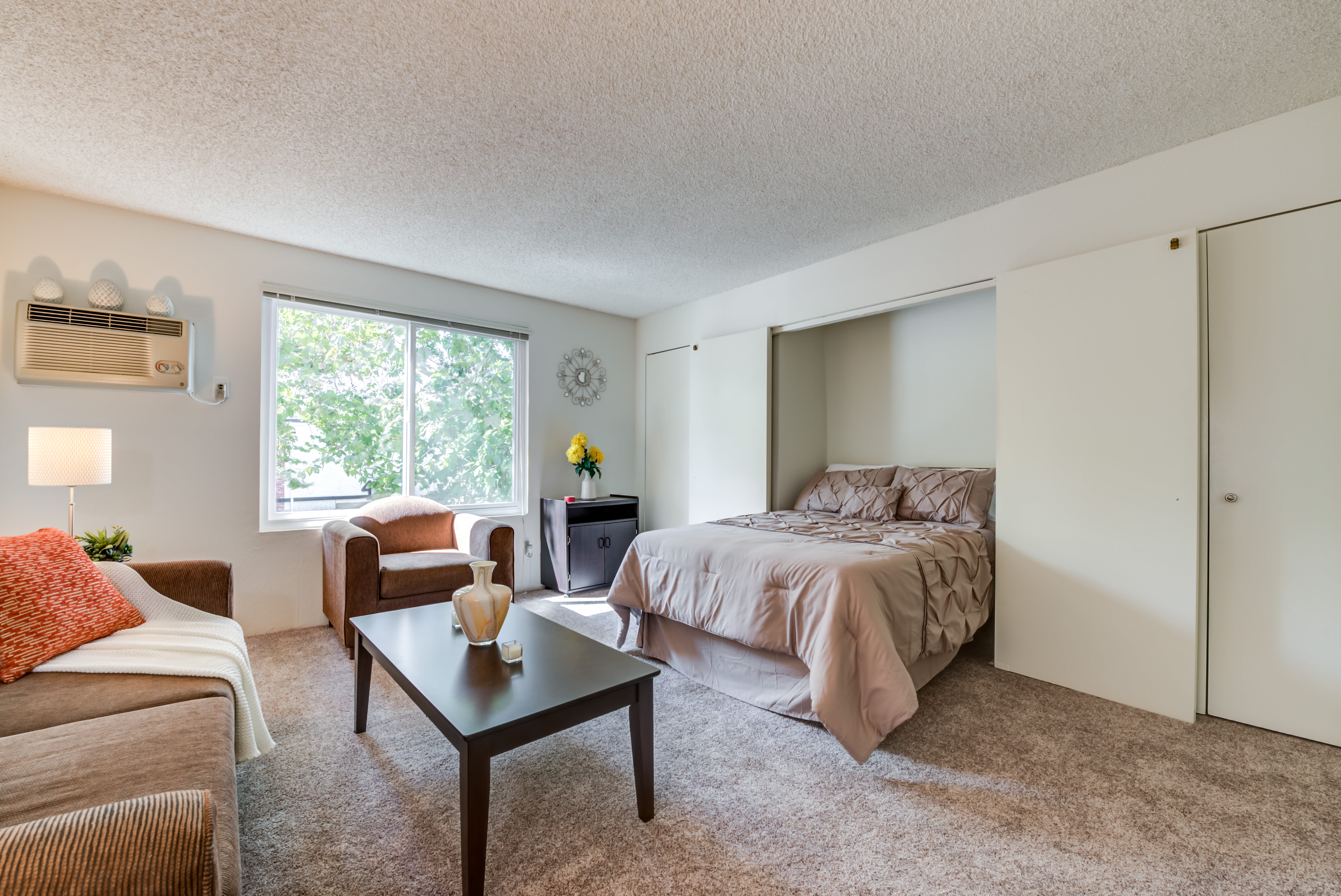 Furnished Studio apartment with ample natural light and murphy bed folded down The Newporter in Tarzana, California