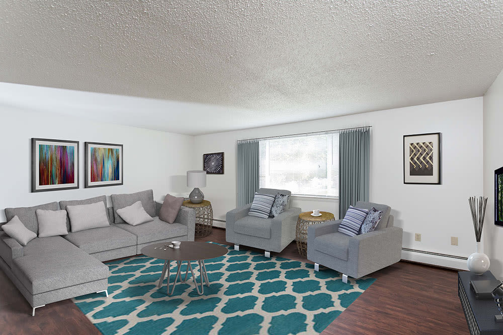 Bright, spacious living room at Perinton Manor Apartments in Fairport, New York