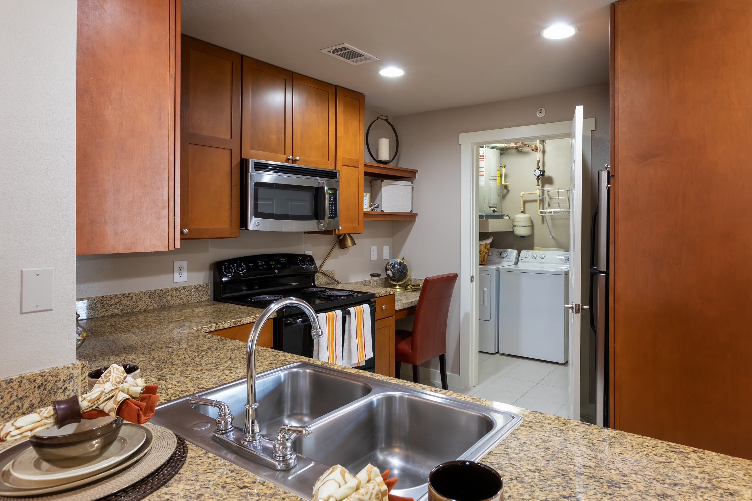 Open-concept floor plan with hardwood floors in the living area of model home at Lakefront Villas in Houston, Texas