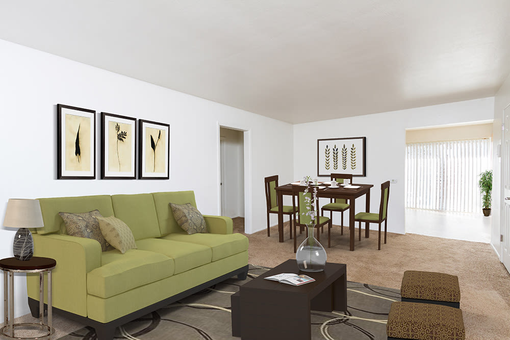 Living room and dining area of a model home at Pittsford Garden Apartments in Pittsford, New York