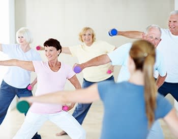 Residents exercising together at Grand Villa of Sarasota in Sarasota, Florida