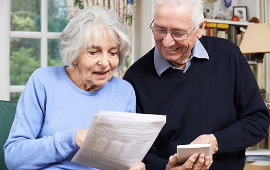 Senior couple reviewing their options at Grand Villa of Sarasota in Sarasota, Florida