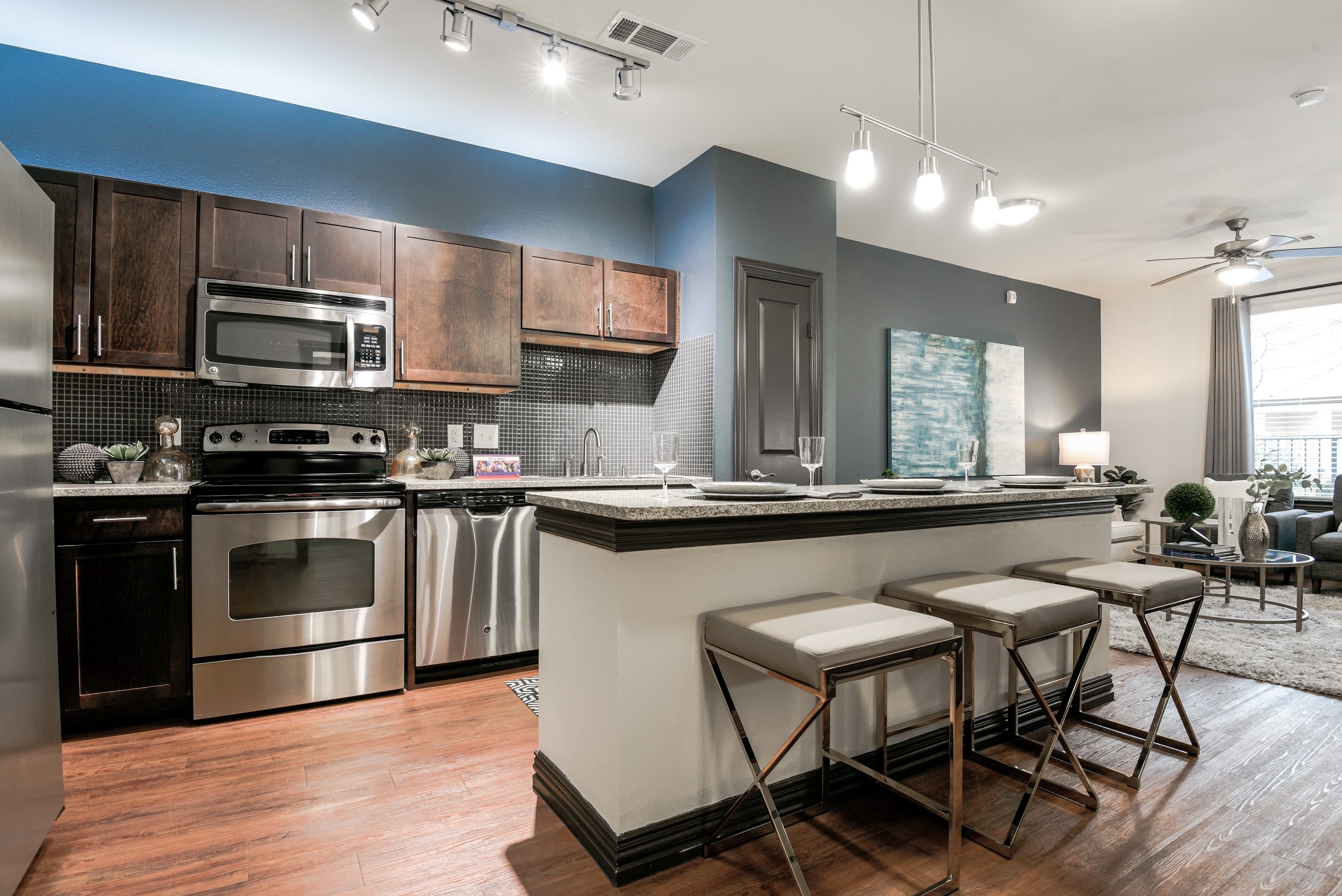 Open-concept floor plan with hardwood floors of model home at The Blvd in Irving, Texas