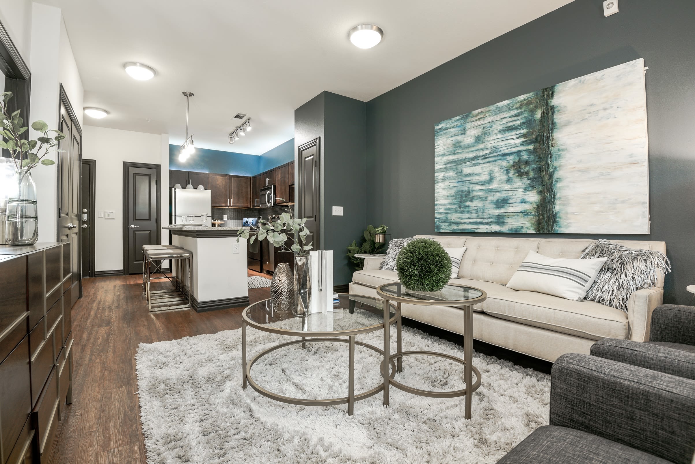Modern decor and hardwood floors in open concept floor plan at The Blvd in Irving, Texas