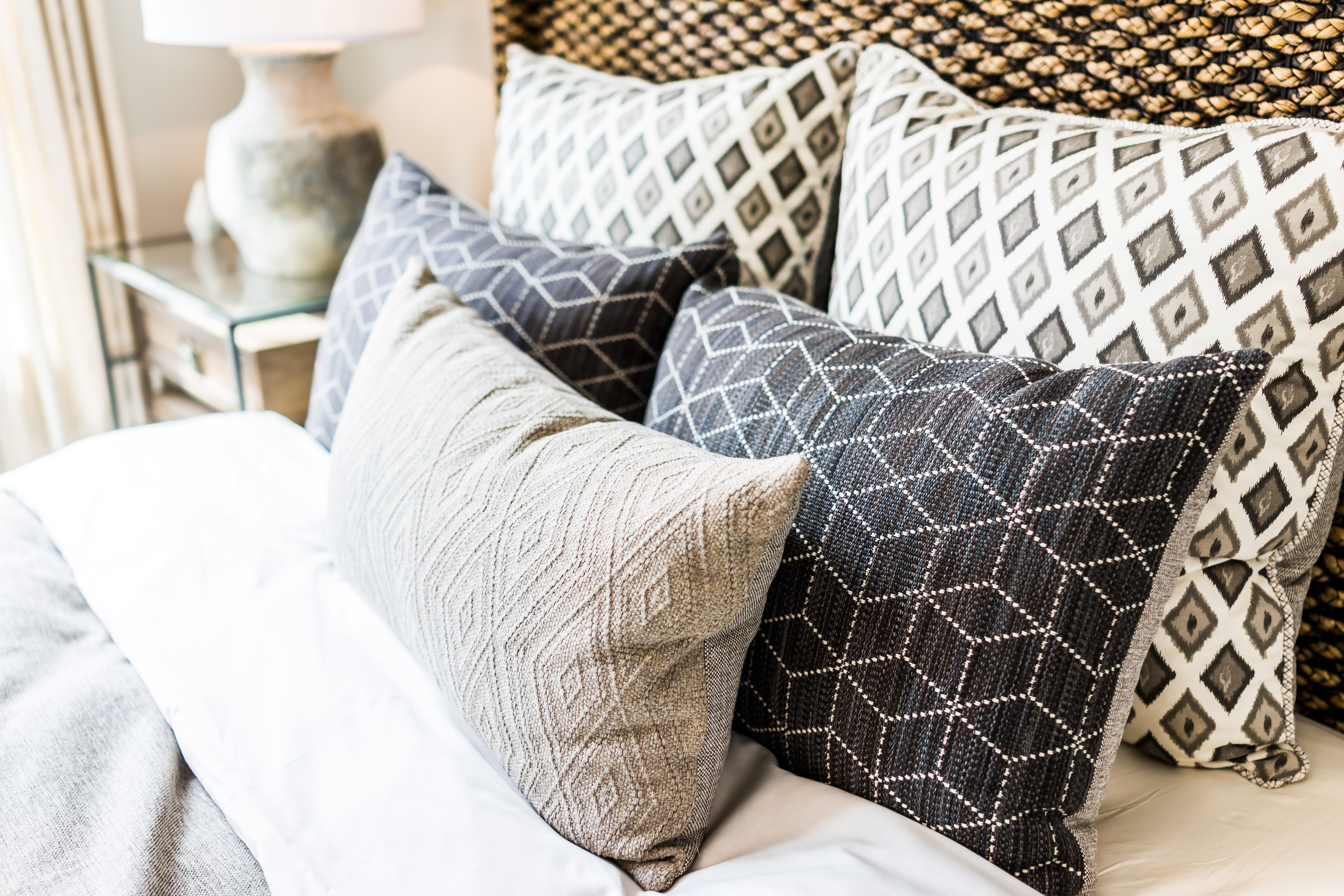 Pillows on a bed in a bright bedroom at One90 Main in Rowlett, Texas