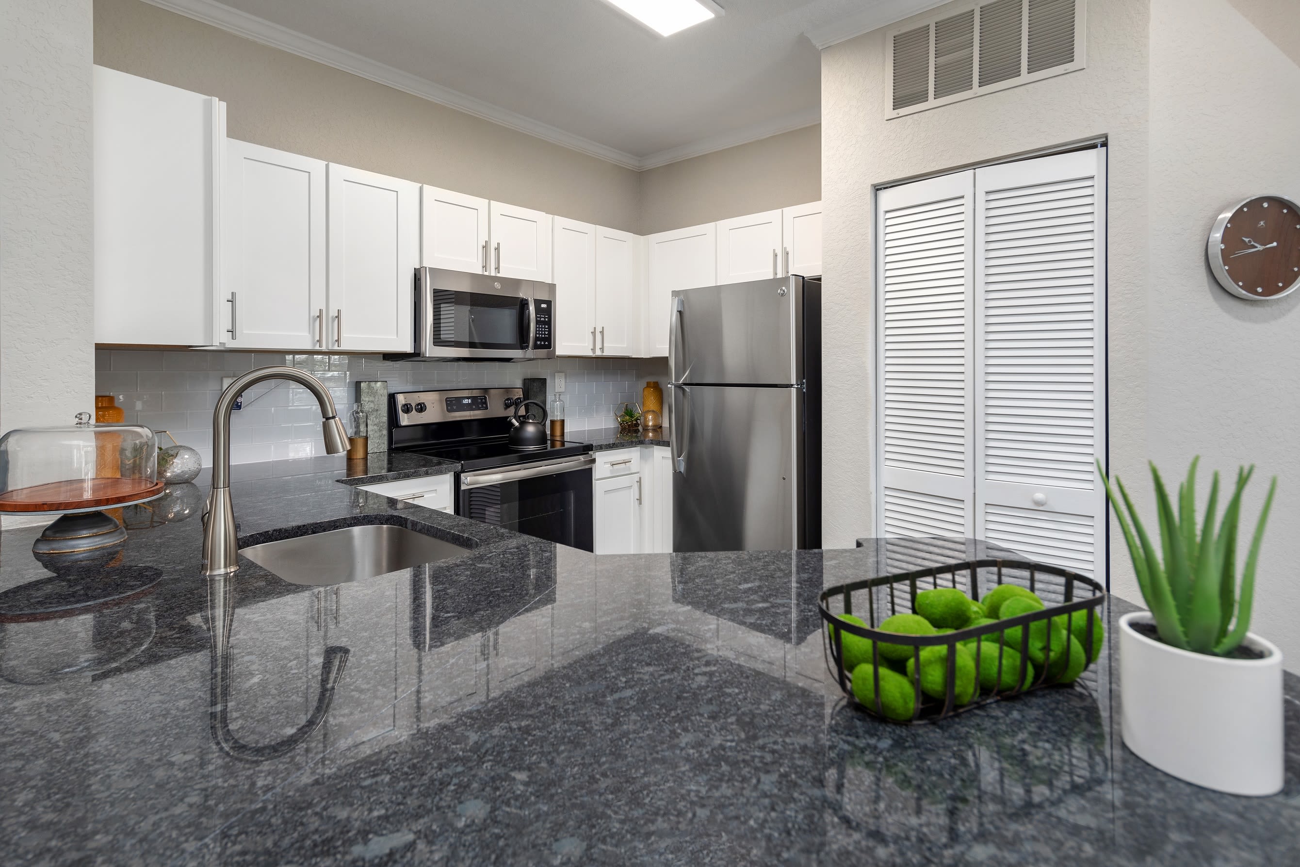 Flowers on the coffee table and hardwood-style floors in a model home at Mezza in Jacksonville, Florida