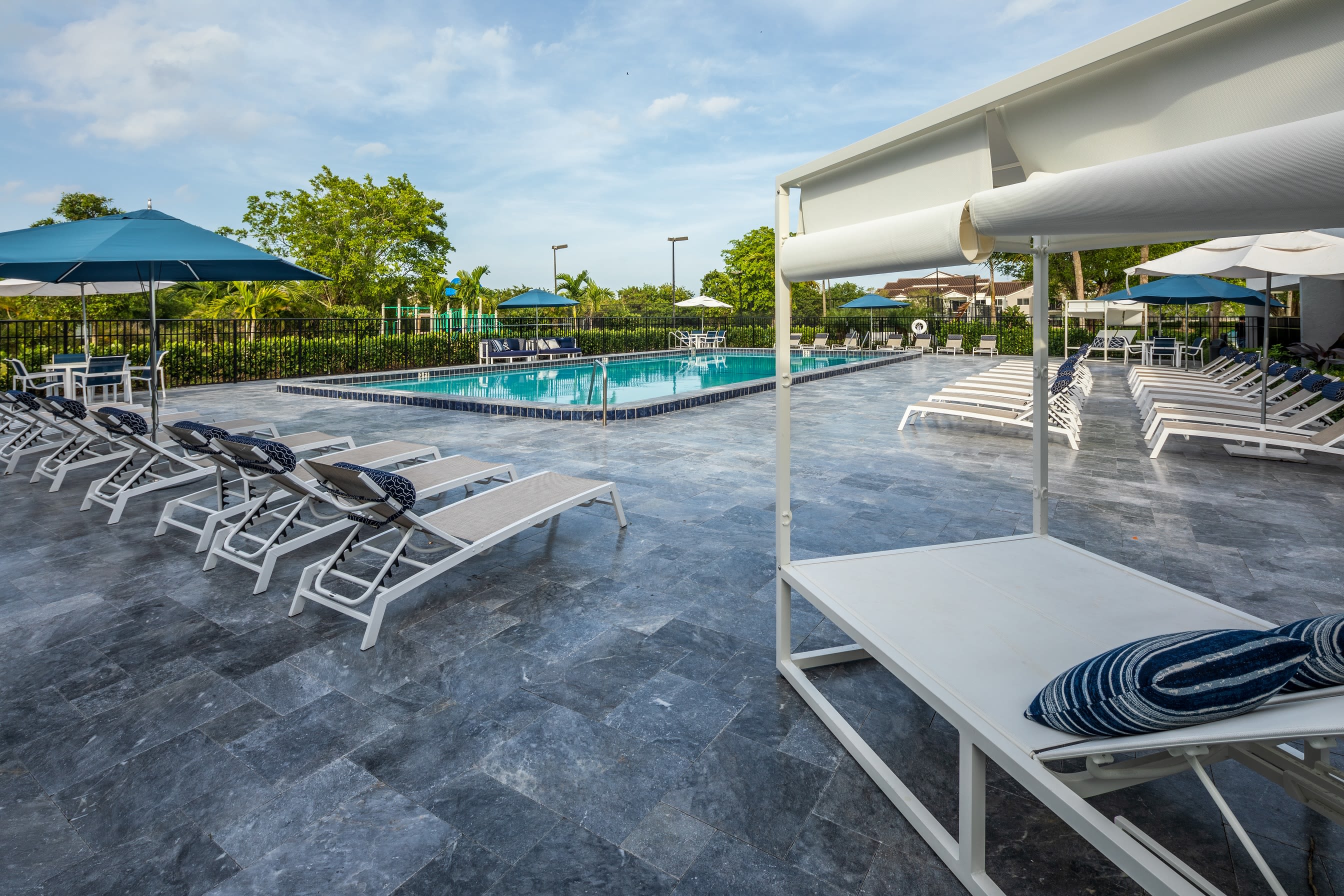 Beautiful outdoor pool with lounge chairs at Cielo Boca in Boca Raton, Florida